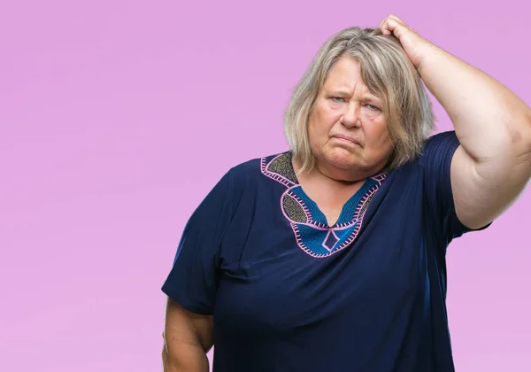 Senior plus size caucasian woman over isolated background confuse and wonder about question. Uncertain with doubt, thinking with hand on head. Pensive concept.