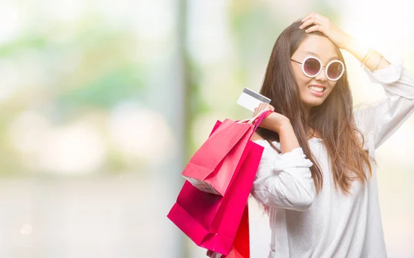 Young Asian Woman Holding Shopping Bags Sales Isolated Background Stressed — Stock Photo, Image