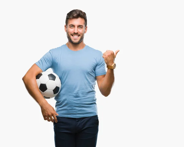 Joven Hombre Guapo Sosteniendo Pelota Fútbol Sobre Fondo Aislado Señalando —  Fotos de Stock