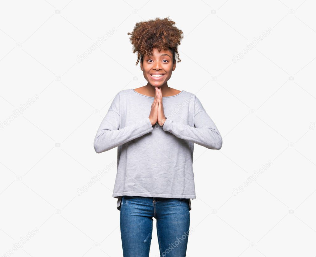 Beautiful young african american woman over isolated background praying with hands together asking for forgiveness smiling confident.