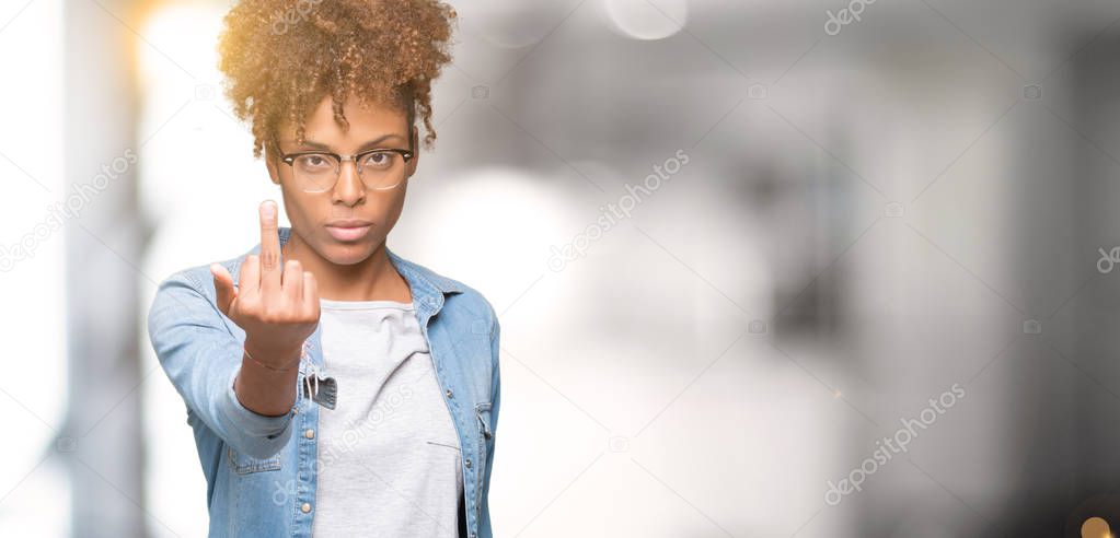 Beautiful young african american woman wearing glasses over isolated background Showing middle finger, impolite and rude fuck off expression