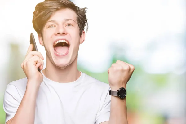 Young Man Talking Smartphone Isolated Background Screaming Proud Celebrating Victory — Stock Photo, Image