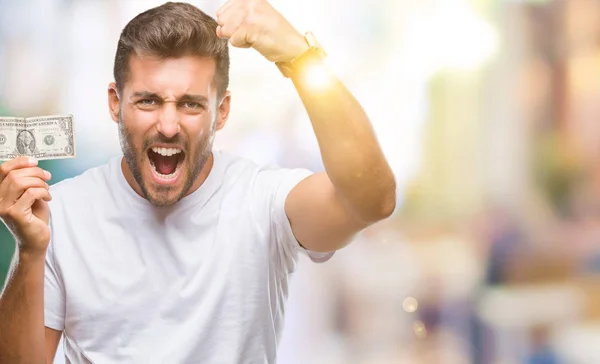 Jovem Homem Bonito Segurando Dólares Sobre Fundo Isolado Irritado Frustrado — Fotografia de Stock