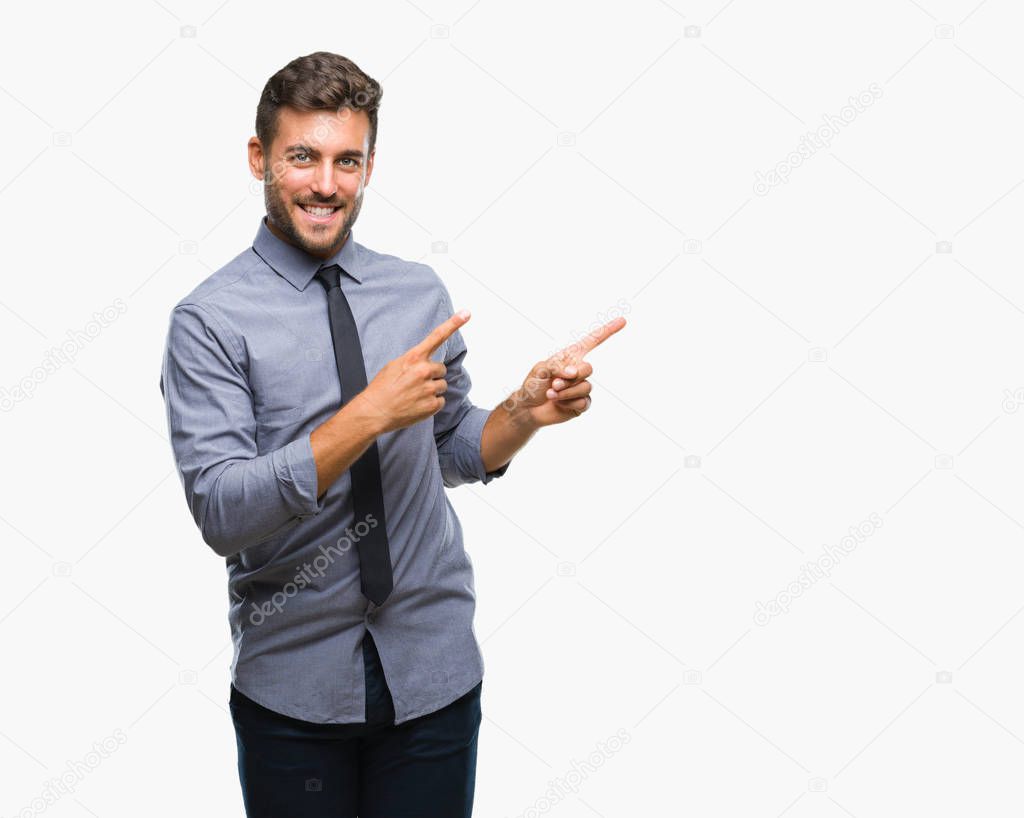 Young handsome business man over isolated background smiling and looking at the camera pointing with two hands and fingers to the side.