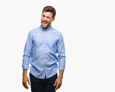 Genç yakışıklı adam seksi bir ifadeyle, neşeli ve mutlu yüzünü kameraya bakarak göz kırpıyor izole arka plan üzerinde.