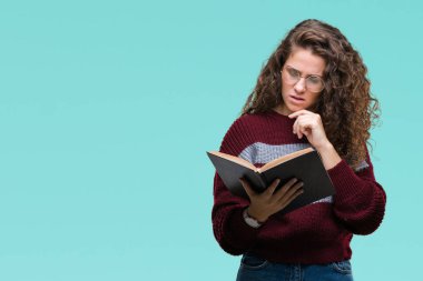Genç esmer kız izole arka plan ciddi bir yüz düşünme hakkında soru, çok karışık bir fikir üzerinde gözlük takan bir kitap okuma