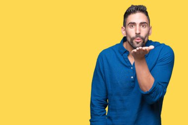 Yakışıklı delikanlı bir öpücük el ile güzel ve seksi olmak hava üfleme kamera bakarak izole arka plan üzerinde. Aşk ifade.