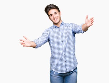 Genç yakışıklı iş adamı sarılmak için kollarını açarak gülümseyerek kameraya bakarak izole arka plan üzerinde. Neşeli ifade kucaklayan mutluluk.