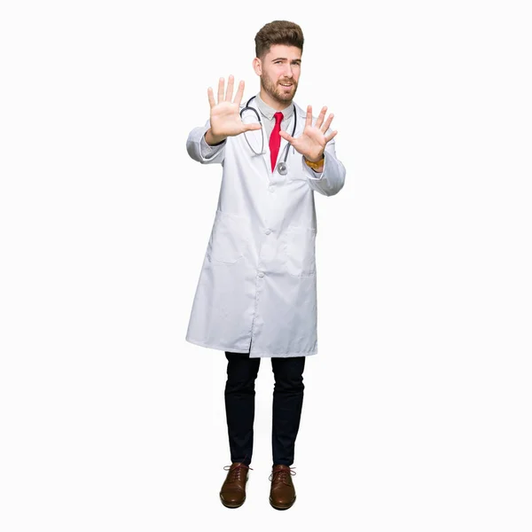 Young Handsome Doctor Man Wearing Medical Coat Afraid Terrified Fear — Stock Photo, Image