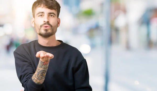 Joven Hombre Guapo Sobre Fondo Aislado Mirando Cámara Soplando Beso —  Fotos de Stock