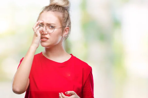 Young Blonde Woman Wearing Glasses Isolated Background Smelling Something Stinky — Stock Photo, Image