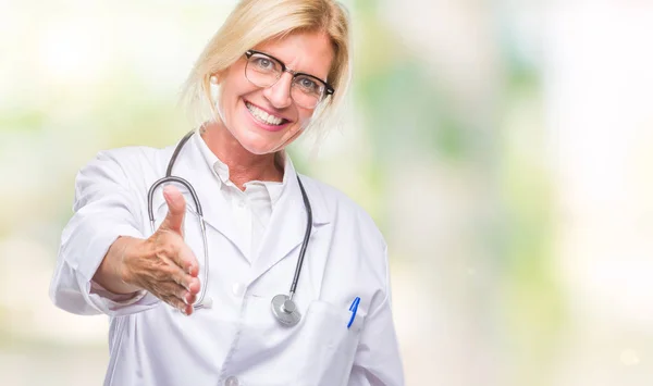 中年金发碧眼的医生妇女在孤立的背景微笑友好提供握手作为问候和欢迎 成功的业务 — 图库照片