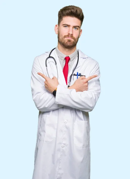 Young Handsome Doctor Man Wearing Medical Coat Pointing Both Sides — Stock Photo, Image