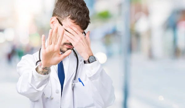 Young Doctor Man Wearing Hospital Coat Isolated Background Covering Eyes — Stock Photo, Image