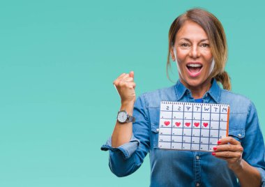 Duygu tezahürat adet takvim gurur çığlık ve zafer ve başarı çok heyecanlı, kutluyor izole arka plan üzerinde tutan orta yaş üst düzey İspanyol kadın