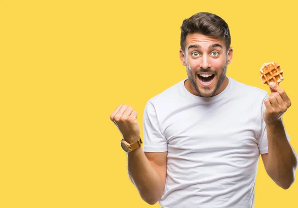 Young Handsome Man Eating Sweet Waffle Isolated Background Screaming Proud — Stock Photo, Image