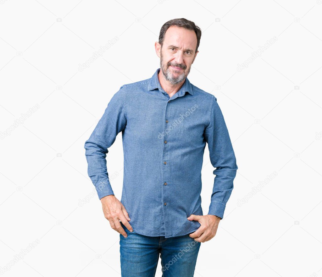 Handsome middle age elegant senior man over isolated background Relaxed with serious expression on face. Simple and natural looking at the camera.