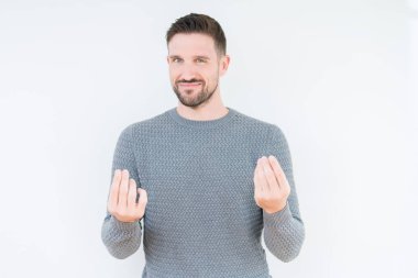 Maaş ödeme için milyoner iş soran izole arka plan yapıyor para hareketi el ile üzerinden rahat kazak giyen genç yakışıklı adam