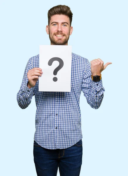 Young Handsome Man Holding Paper Question Mark Pointing Showing Thumb — Stock Photo, Image