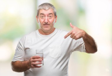 Üst düzey yakışıklı sürpriz yüz işaret parmağı kendini izole arka plan üzerinde bardak su içme