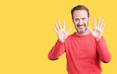 Gösterilen arka plan üzerinde kış kazak giymiş yakışıklı orta yaş ağarmış komuta sizde izole ve parmakları ile işaret kendinden emin ve mutlu gülümseyerek süre on numara.