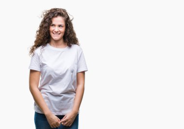 Güzel esmer kıvırcık saçlı Genç kız görünümlü yan ve dik dik bakma uzağa düşünce gülümseyen izole arka plan üzerinde rahat t-shirt giyen.