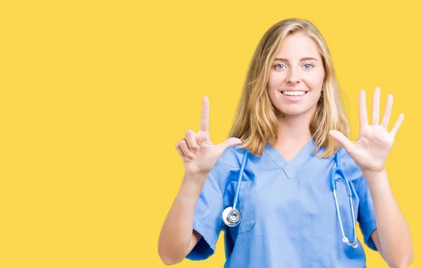 美丽的年轻医生妇女穿着医疗制服在孤立的背景显示和手指指向七 同时微笑着自信和快乐 — 图库照片
