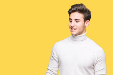 Üzerinde boğazlı kazak giyen genç yakışıklı adam arka plan uzak tarafına gülümseme ile yüzünde, doğal ifade arıyorum izole. Kendine güvenen gülüyor.