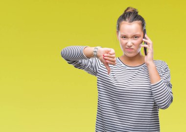 Genç güzel beyaz kadın Smartphone'da kızgın yüzü, eksi işareti aşağı antipati başparmak ile gösterilen, ret kavramı ile izole arka plan üzerinde söz