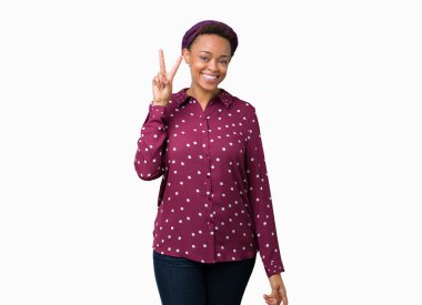 Gösterilen ve parmakları ile işaret izole arka plan üzerinde başörtüsü giyen güzel genç Afro-Amerikan kadın ikincisi ise kendinden emin ve mutlu gülümseyerek.