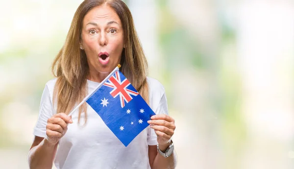 驚き顔 恐怖表現と興奮とショックで怖いの孤立した背景にオーストラリアの国旗を保持している中年ヒスパニック系女性 — ストック写真