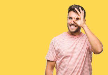 Genç yakışıklı adam gülümsüyor, parmakları ile mutlu yüz üzerinden seyir göz el ile ok jest yapıyor izole arka plan üzerinde.