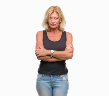 Orta yaş sarışın kadın izole arka plan şüpheci ve çapraz kolları olan yüzündeki gergin, onaylamayan ifade yüzünden. Negatif kişi.