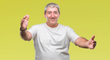 Sarılmak için kollarını açarak gülümseyerek kameraya bakarak izole arka plan üzerinde yakışıklı komuta sizde. Neşeli ifade kucaklayan mutluluk.