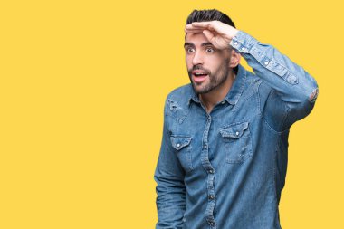 Yakışıklı delikanlı izole arka plan çok mutlu ve gülümseyen uzakta el ile üzerine kafa seyir üzerinde. Arama kavramı.