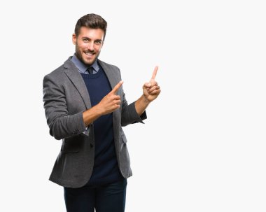 Genç yakışıklı iş adamı gülümseyen ve iki elleri ve parmakları ile tarafına işaret kamera bakarak izole arka plan üzerinde.