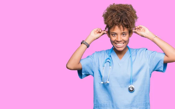 Young African American Doctor Woman Isolated Background Smiling Pulling Ears — Stock Photo, Image