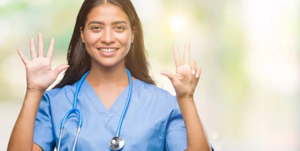孤立した背景表示と指で上向きに若いアラブ医師外科医女性数 自信を持って 幸せな笑みを浮かべて — ストック写真
