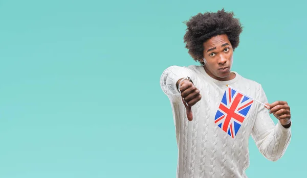 Afro american man flag of United Kingdom over isolated background with angry face, negative sign showing dislike with thumbs down, rejection concept