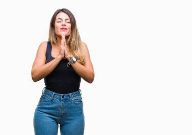 İzole arka plan birlikte emin gülümseyen bağışlanmak ellerle dua genç güzel kadın.