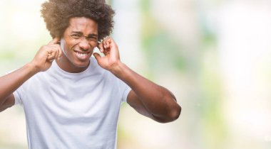 Yüksek sesle müzik gürültü rahatsız ifade parmaklarıyla kulaklarıyla kapsayan izole arka plan üzerinde Afro Amerikalı adam. Sağır kavramı.