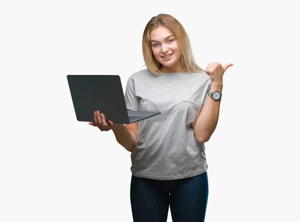 年轻的高加索妇女使用计算机笔记本电脑在孤立的背景指向和显示与愉快的面孔微笑的边 — 图库照片