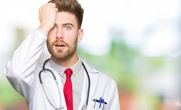 Young Handsome Doctor Man Wearing Medical Coat Surprised Hand Head — Stock Photo, Image