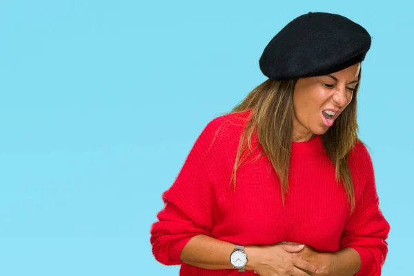 Middle age adult woman wearing fashion beret over isolated background with hand on stomach because nausea, painful disease feeling unwell. Ache concept.