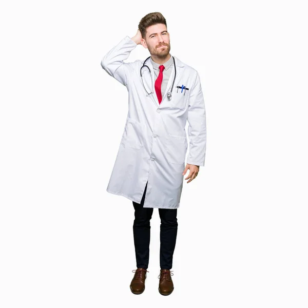 Young Handsome Doctor Man Wearing Medical Coat Confuse Wonder Question — Stock Photo, Image