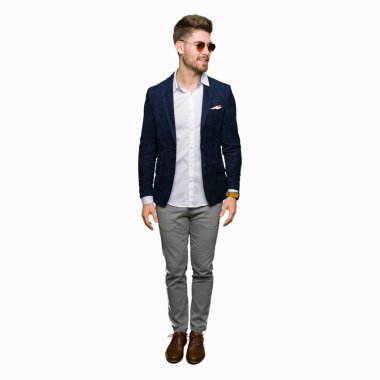 Güneş gözlüğü ve uzak tarafına gülümseme ile yüzünde, doğal ifade arıyorum moda ceket giyen genç yakışıklı zarif adam. Kendine güvenen gülüyor.