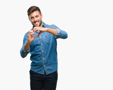 Yakışıklı delikanlı aşık kalp simgesi ve elleriyle şekil gösteren gülümseyen izole arka plan üzerinde. Romantik kavramı.