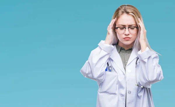 Young blonde doctor woman over isolated background with hand on head for pain in head because stress. Suffering migraine.