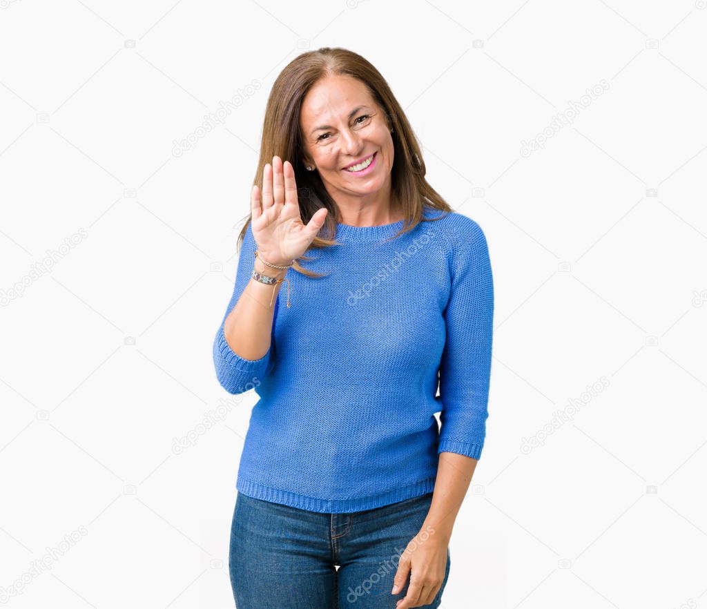 Middle age beautiful woman wearing winter sweater over isolated background Waiving saying hello happy and smiling, friendly welcome gesture