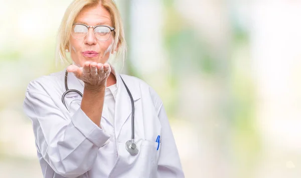 Middle Age Blonde Doctor Woman Isolated Background Looking Camera Blowing — Stock Photo, Image